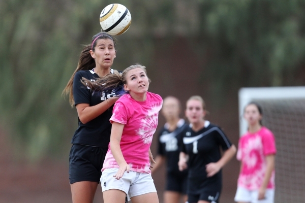 Palo Verde‘s Jadyn Nogues (18), left, leaps for a header against Legacy in their girls ...