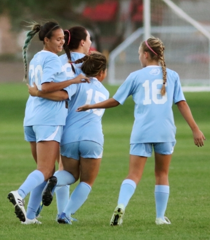 CentennialÃ­s Kellsey Meechudhone (cq), left, is swarmed by teammates Amanda Gebheim, Vict ...