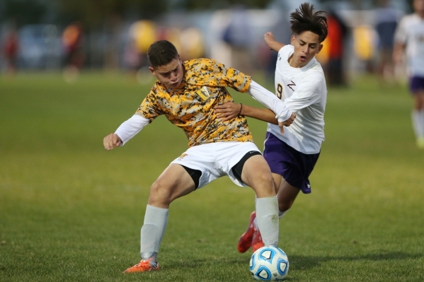 Durango‘s Jaime Munguia (9) fights for possession of the ball against Bonanza‘s ...