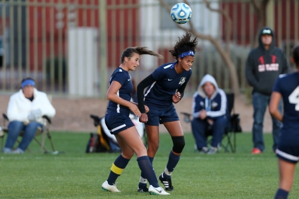 Foothill‘s Katherine Ballou (6), left, and Rae Burrell (12), go up for the ball agains ...