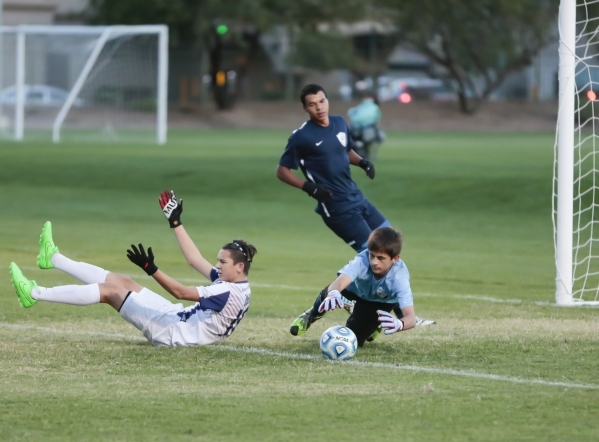 Coronado‘s Preston Judd (10) takes a fall as Foothill‘s goalie Ricky Glogart d ...