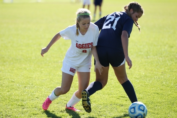 Arbor View‘s Hannah Ferrara (8) fights for ball possession against Centennial‘s ...