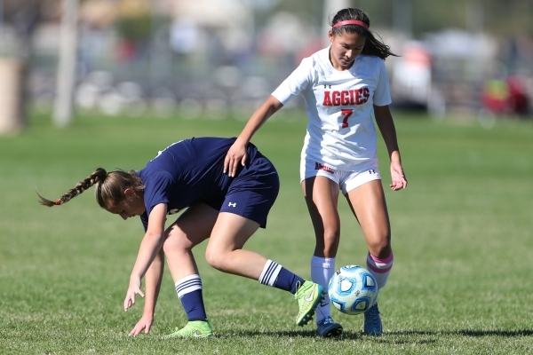 Arbor View‘s Katelyn Laurente (7) win the ball against Centennial‘s Marcella Bro ...