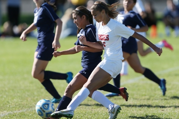 Arbor View‘s Deja Erickson (17) kicks the ball for a goal under pressure from Centenni ...