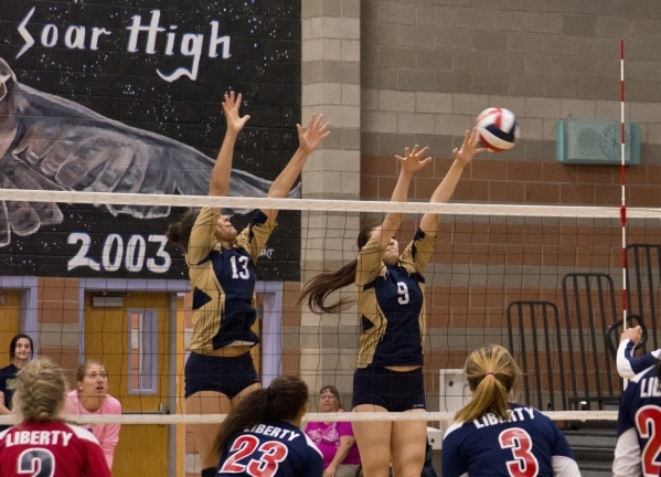 Foothill‘s Alyssa McCoy (13) and Tessa Michalosky (9) jump to block the ball during th ...