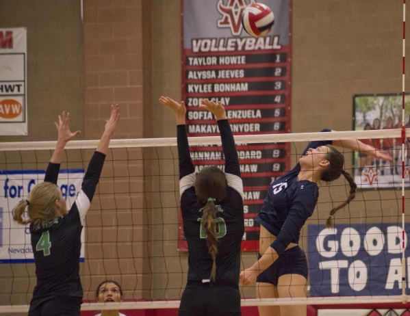 Shadow Ridge‘s Whittnee Nihipali (15) hits the ball over the net during the Sunset Reg ...