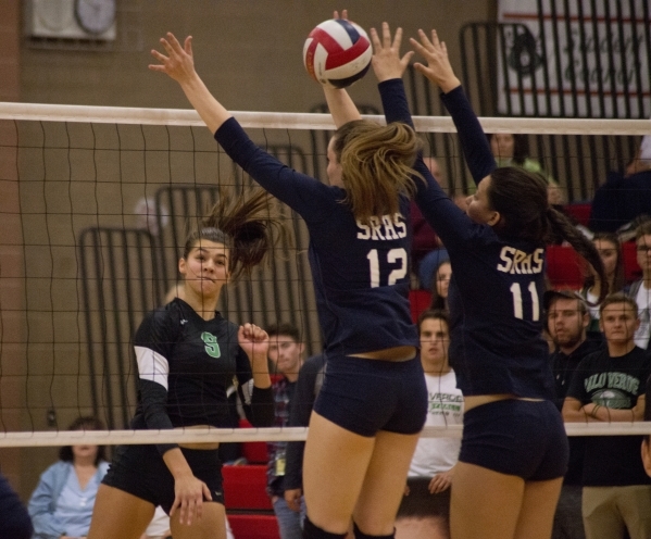 Palo Verde‘s Kayla Kinney (9) hits the ball through the block of Shadow Ridge‘s ...