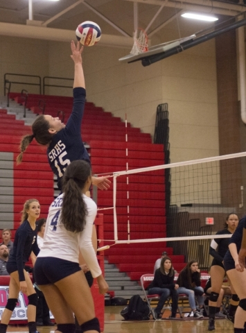 Shadow Ridge‘s Whittnee Nihipali (15) extends her reach to get the ball over the net d ...