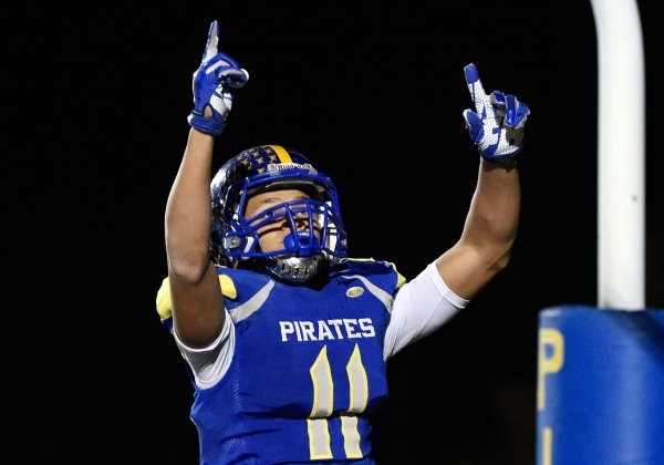 Moapa Valley‘s R.J. Hubert makes an extra effort to score a touchdown during a high sc ...