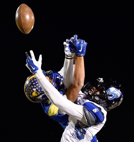 Moapa Valley‘s R.J. Hubert breaks up a reception against Desert Pines‘ Randal G ...