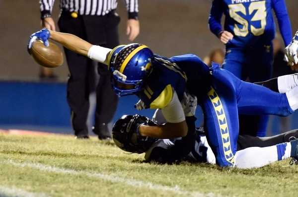 Moapa Valley‘s R.J. Hubert makes an extra effort to score a touchdown during a high sc ...