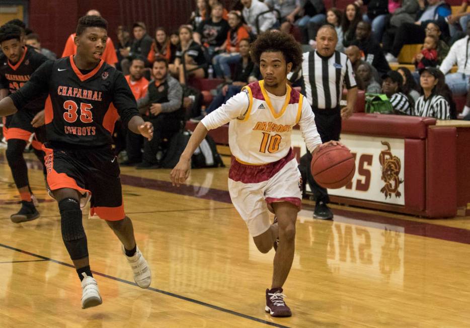 Del Sol’s Devonte Anton Villarta (10) drives the ball as Chaparral’s Meshach Haw ...