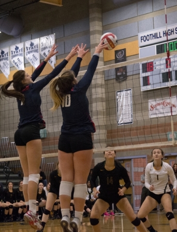 Coronado‘s Nikki Jackson (7) and Emily Bender (10) block the ball during the division ...