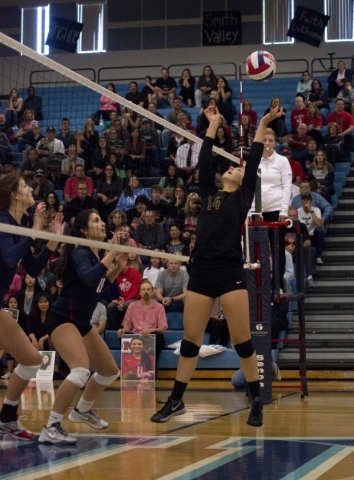 Bishop Manogue‘s Mikaela DeRicco (14) sets the ball during the division I state volley ...