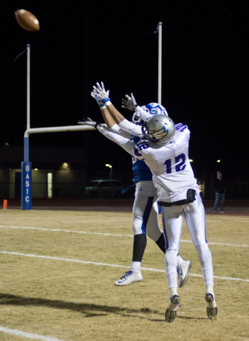 Silverado‘s Devion Clayton (12) and Basic‘s Brian Evans (9) go for the ball duri ...