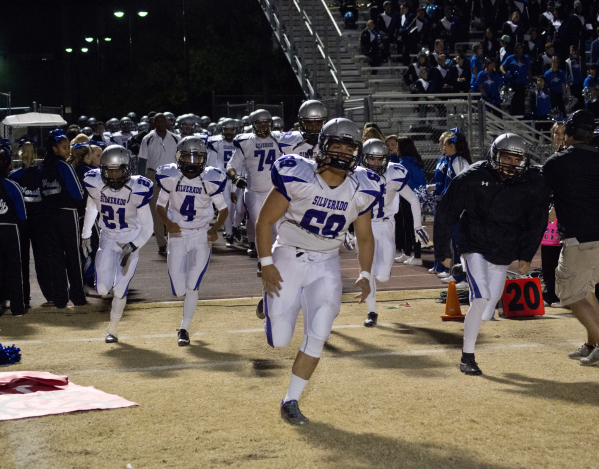 The Silverado High School football team runs onto the field before the Sunrise Region semifi ...