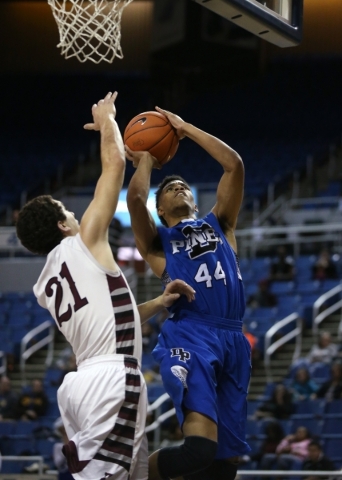 Desert Pines‘ Trevon Abdullah shoots past Elko defender Nathan Klekas during the NIAA ...