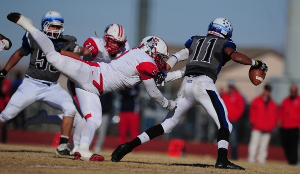 Liberty linebacker Kaimi Batoon (5) sacks Basic Wolves quarterback Aeneas McAllister (11) in ...