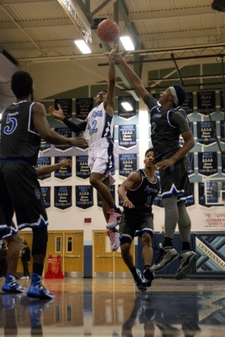 Centennial‘s Warren Price (12) shoots the ball during their game against Desert Pines ...