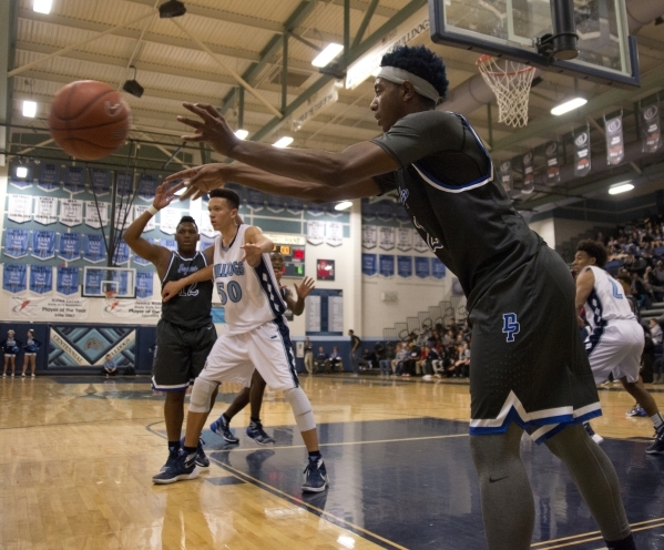 Desert Pines‘ Jordan Simon (2) passes the ball into play during their game at Centenni ...