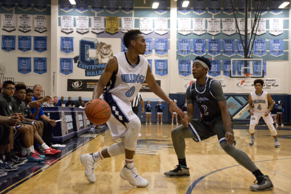 Centennial‘s Troy Brown (0) looks to get around Desert Pines‘ Jordan Simon (2) d ...