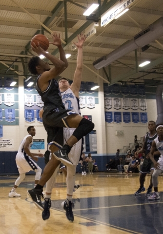 Desert Pines‘ Derrick Coleman (32) looks to shoot the ball during their game at Centen ...