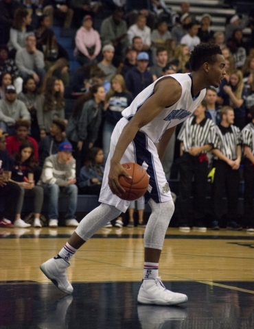 Centennial‘s Troy Brown (0) looks around the court during their game against Desert Pi ...