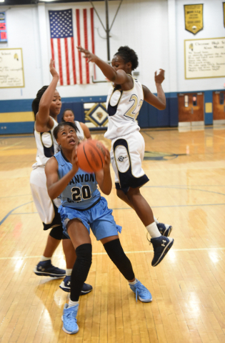 Canyon Springs Alexia Thrower (20) goes up for a layup against Cheyenne‘s defense duri ...