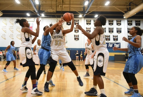 Cheyenne‘s Da‘Vione Lomax (32) grabs a rebound against Canyon Springs during the ...