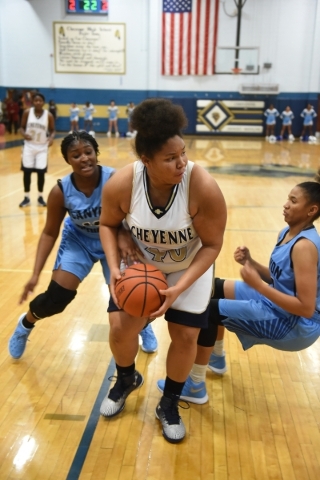 Cheyenne‘s Koreyl Godbolt (40) goes up for a layup against Canyon Springs defenders du ...