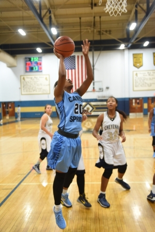 Canyon Springs Alexia Thrower (20) goes up for a layup against Cheyenne‘s defense duri ...