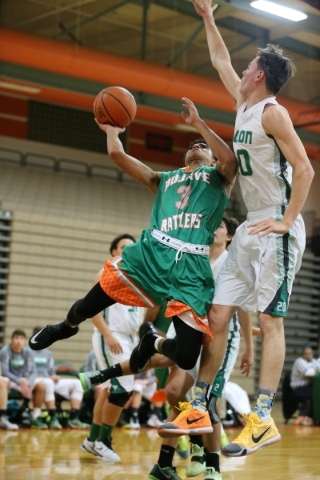 Mojave‘s Daryl Adams (3) goes up for a shot under pressure from Churchill County&lsquo ...