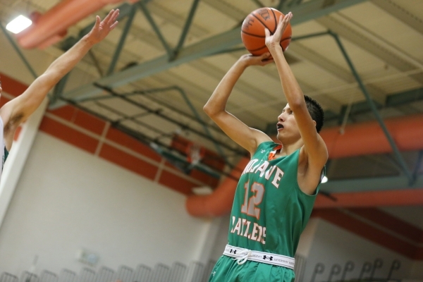 Mojave‘s Jonathan Rodriguez (3) goes up for a shot against Churchill County in their b ...