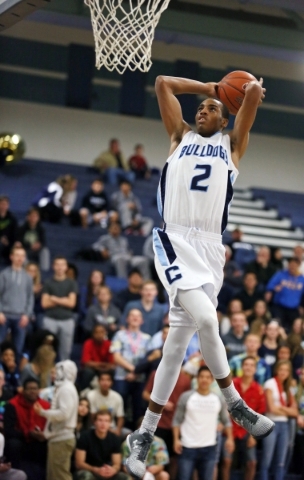 CentennialÃ¾ÃÃ´s Troy Brown goes up for a dunk during a basketball game against Duran ...