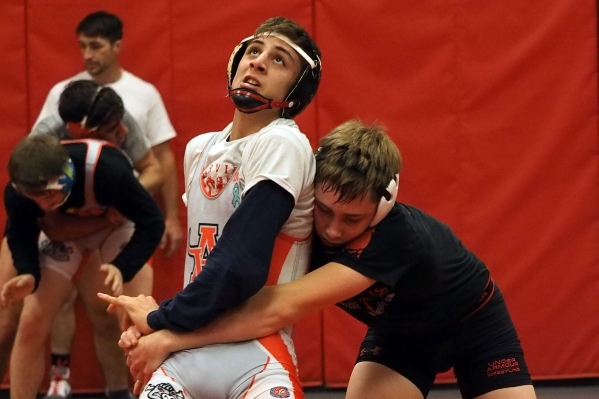 Wrestlers Lawrence Vigil, grey uniform, and Ryder Marchello, black uniform, practice moves a ...