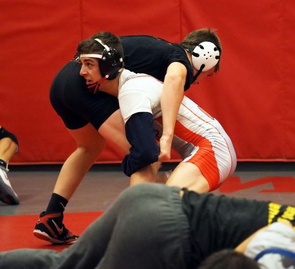 Wrestlers Lawrence Vigil, grey uniform, and Ryder Marchello, black uniform, practice moves a ...