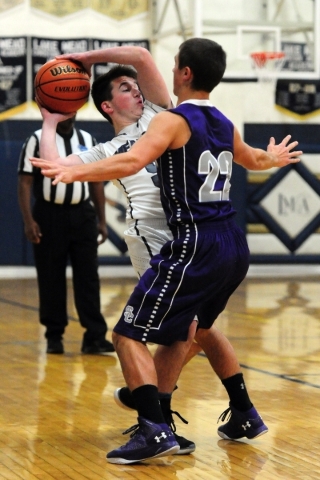 The Meadows School guard Adam Cohen (5) looks to pass as Spring Creek guard Jason Painter ( ...