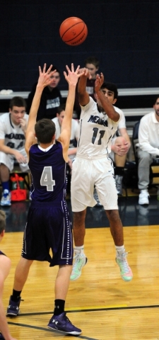 The Meadows School guard Asheesh Chopra (11) passes in front of Spring Creek guard Cooper Ca ...