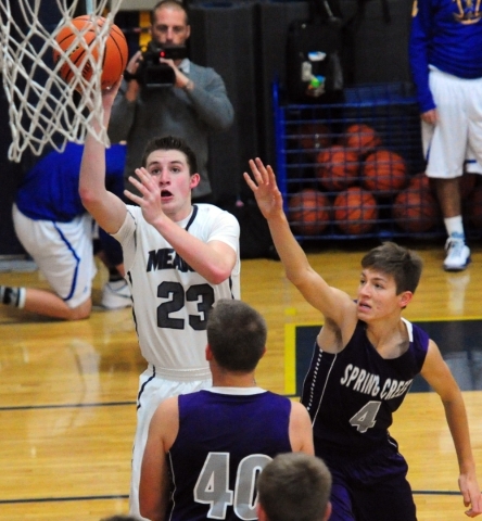 The Meadows School guard Jake Epstein (23) shoots as Spring Creek guard Cooper Cavaness (4) ...