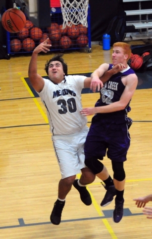 The Meadows School forward Alex Agrawal (30) is fouled by Spring Creek forward Jake Miner (3 ...