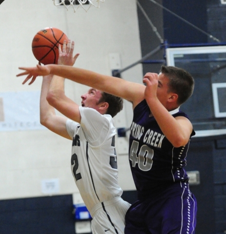 Spring Creek forward Spencer Woodland (40) defends The Meadows School forward Connor Bucknam ...