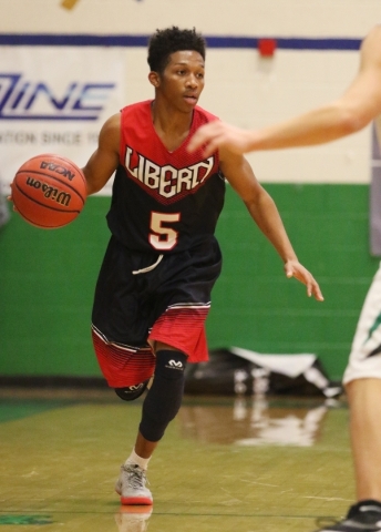 LibertyÃ­s David Bravo dribbles the ball during a basketball game against Green Valley at ...