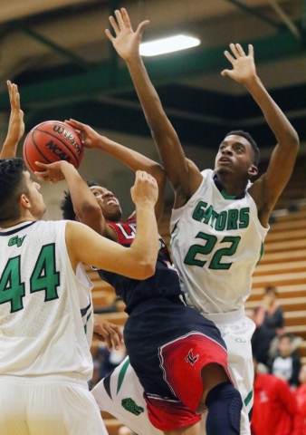 LibertyÃ­s David Bravo, center, gets tangled with Green Valley defense Ali Amhaz, left, an ...