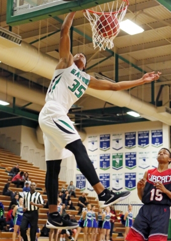 Green ValleyÃ­s Isiah Macklin (cq), left, dunks near LibertyÃ­s Cameron Burist during a ...