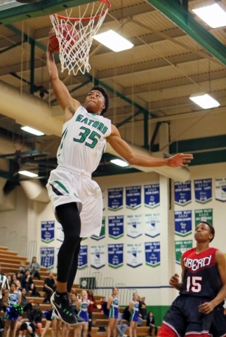 Green ValleyÃ­s Isiah Macklin (cq), left, goes up for a dunk near LibertyÃ­s Cameron Bur ...