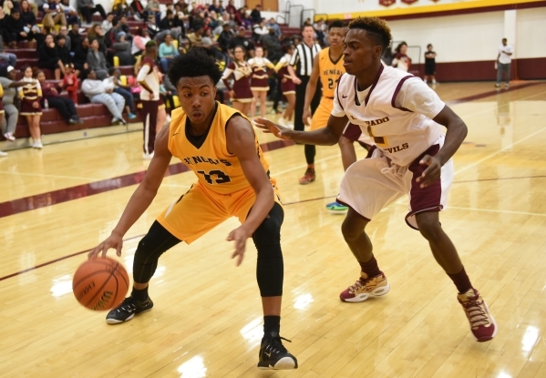 Bonanza‘s Jamal Logan(13) drives to the basket against Eldorado‘s Carl Crayon (1 ...