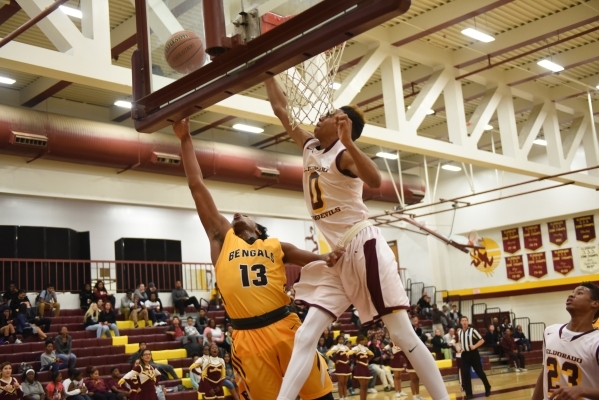 Bonanza‘s Jamal Logan (13) goes up for a layup against Eldorado‘s Dereonte Allen ...