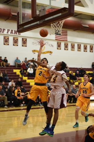 Bonanza‘s Travis Jenkins (2) goes up for a layup against Eldorado‘s Carmonte Jon ...