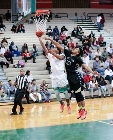 Mojave senior Daryl Adams (3) tries to lay the ball in while Sierra Vista junior Chris McCoy ...