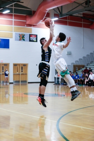 Sierra Vista sophomore Maka Ellis (32), left, attempts a shot from the three point line, as ...